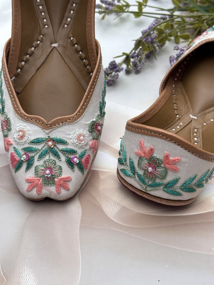 White base multi coloured hand embroidered Punjabi jutti for women, pure leather, double cushioned jutti by sandoori jutti, free shipping, free exchange, latest design, branded jutti, main colours green, pink, peach, white