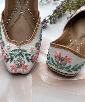 White base multi coloured hand embroidered Punjabi jutti for women, pure leather, double cushioned jutti by sandoori jutti, free shipping, free exchange, latest design, branded jutti, main colours green, pink, peach, white