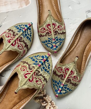 Biba Jutti with Phirozy and Magenta velvet inserts and hand embroidered with Golden tilla (Zari). A stunning blend of tradition and comfort. Lovingly handcrafted by skilled artisans, this Punjabi jutti, also known as mojari or Delhi fashion jutti