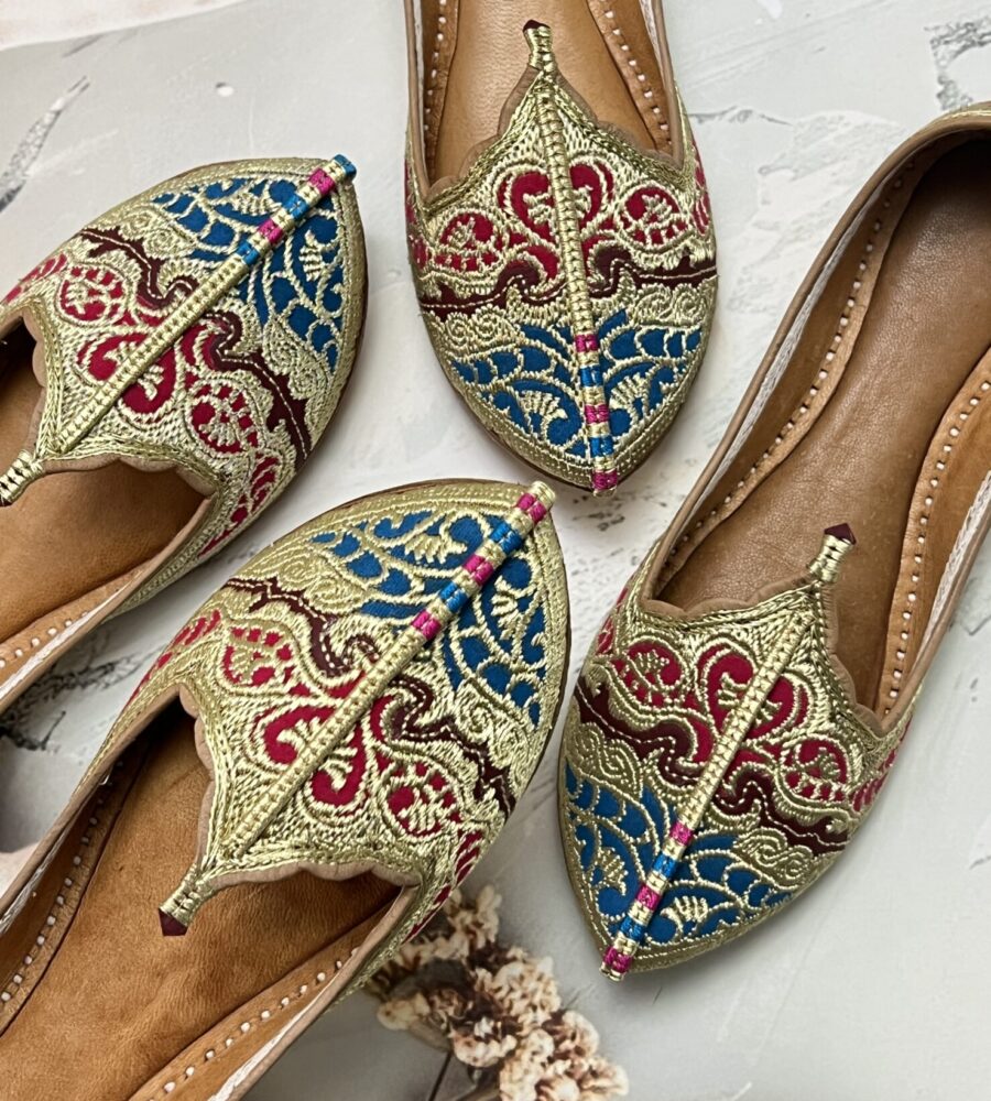 Biba Jutti with Phirozy and Magenta velvet inserts and hand embroidered with Golden tilla (Zari). A stunning blend of tradition and comfort. Lovingly handcrafted by skilled artisans, this Punjabi jutti, also known as mojari or Delhi fashion jutti