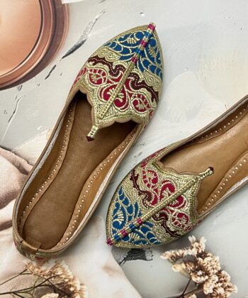 Biba Jutti with Phirozy and Magenta velvet inserts and hand embroidered with Golden tilla (Zari). A stunning blend of tradition and comfort. Lovingly handcrafted by skilled artisans, this Punjabi jutti, also known as mojari or Delhi fashion jutti