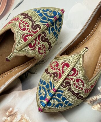 Biba Jutti with Phirozy and Magenta velvet inserts and hand embroidered with Golden tilla (Zari). A stunning blend of tradition and comfort. Lovingly handcrafted by skilled artisans, this Punjabi jutti, also known as mojari or Delhi fashion jutti